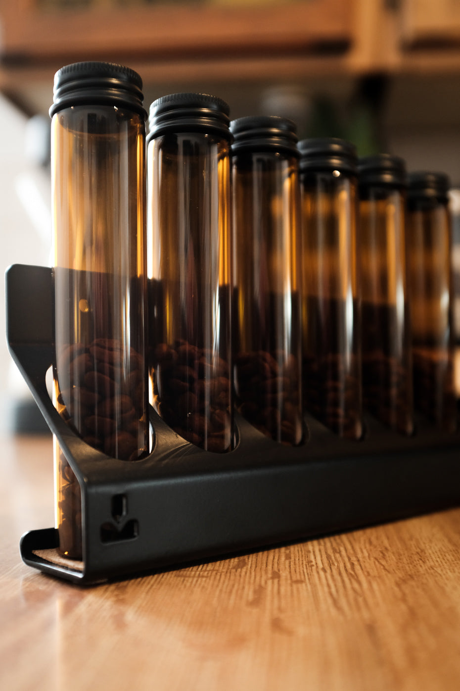 coffee bean cellars vaults capsules storage amber glass black steel proper by design